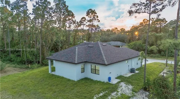 a aerial view of a house with a yard table and chairs