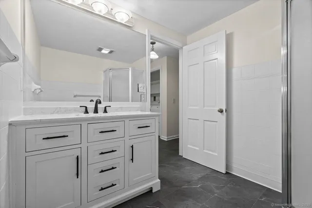 a view of empty room with wooden floor and fireplace