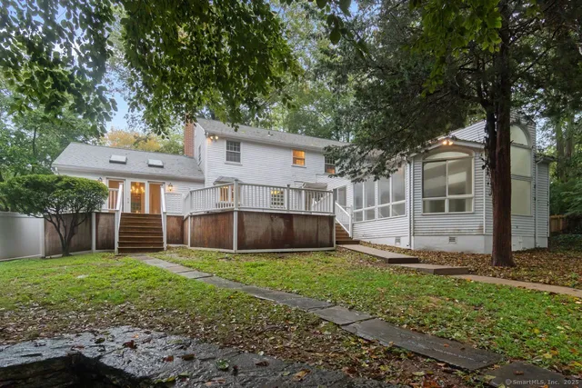 a view of a house with a yard and sitting area