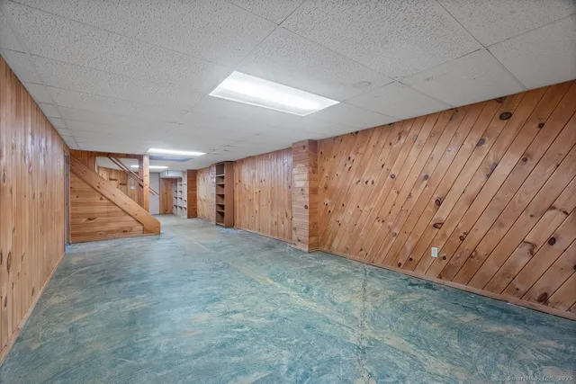 a view of a livingroom with stairs and furniture