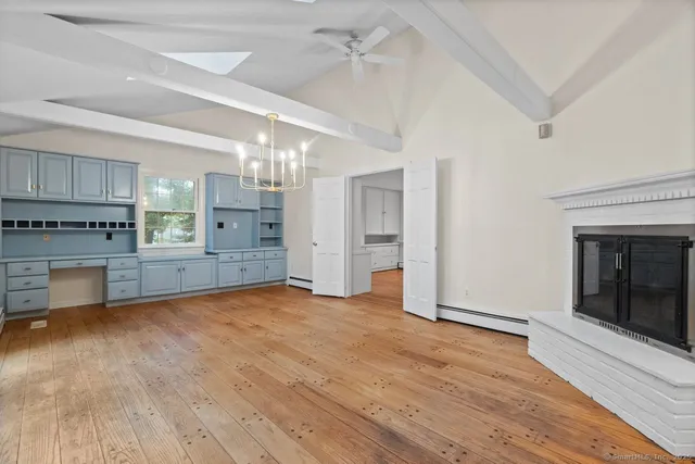 a view of a room with wooden floor and windows