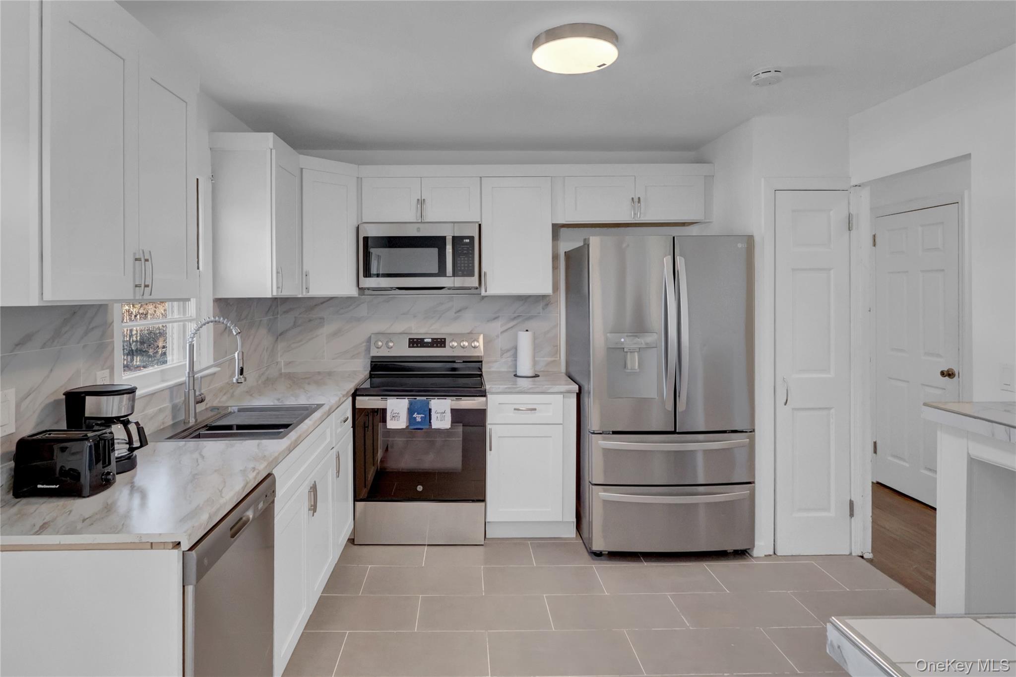 57 Middle Island Road Medford, NY 11763 - Photo 8 of 28 a kitchen with cabinets stainless steel appliances and a counter space
