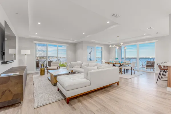 a living room with furniture and a wooden floor