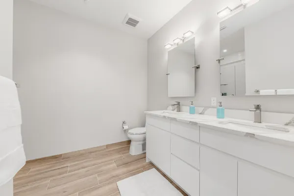 a bathroom with a toilet and a shower