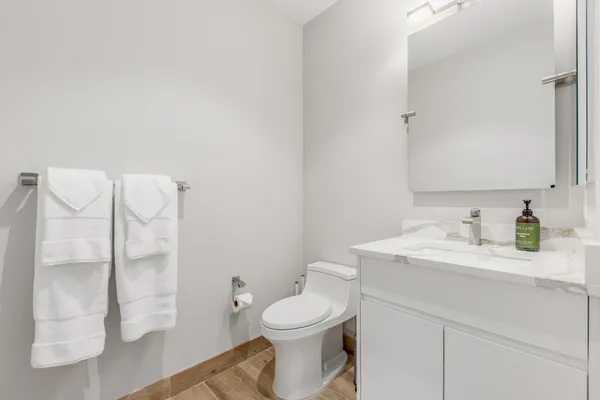 a bathroom with a sink a toilet and a mirror