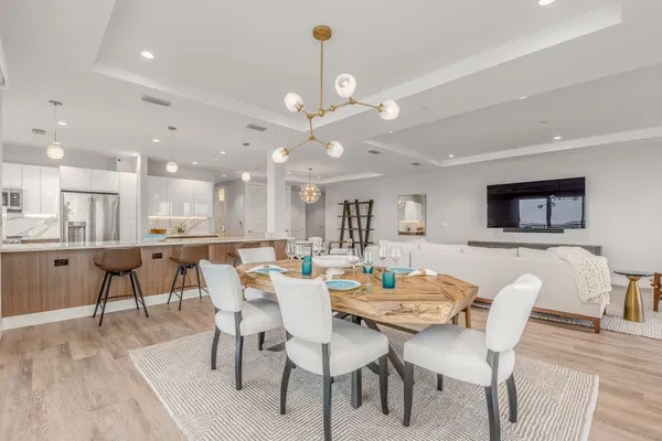 a view of a dining room with furniture and wooden floor
