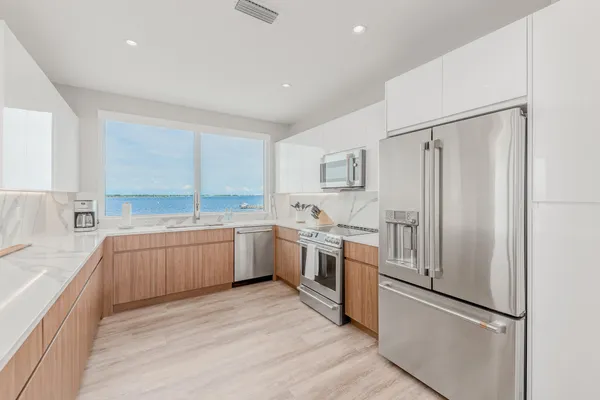 a kitchen with a refrigerator sink and stainless steel appliances