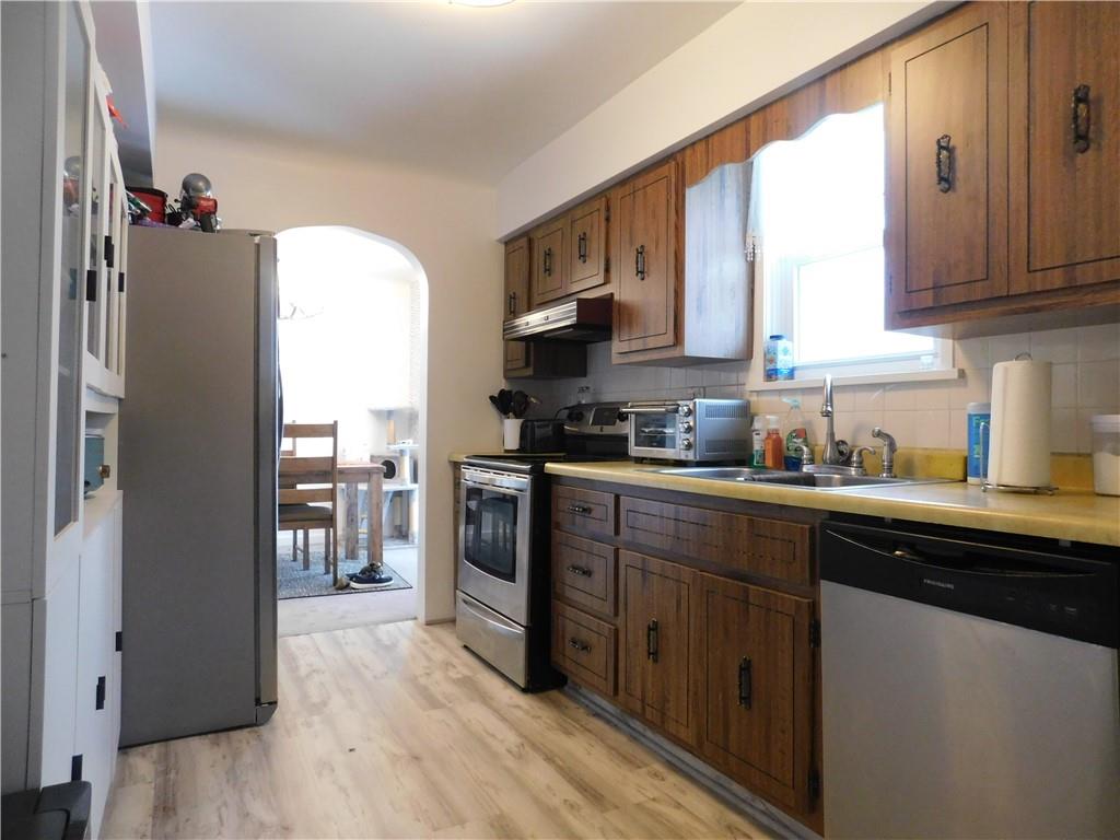 1687 Rte 481 Charleroi, PA 15022 - Photo 14 of 30 a kitchen with stainless steel appliances granite countertop a refrigerator a sink dishwasher a stove and white countertops with wooden floor