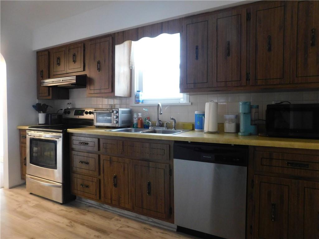 1687 Rte 481 Charleroi, PA 15022 - Photo 15 of 30 a kitchen with stainless steel appliances granite countertop wooden cabinets a stove a sink and dishwasher with wooden floor