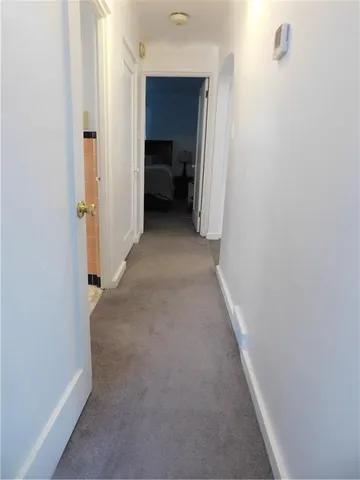 a view of a hallway with a livingroom and a hallway