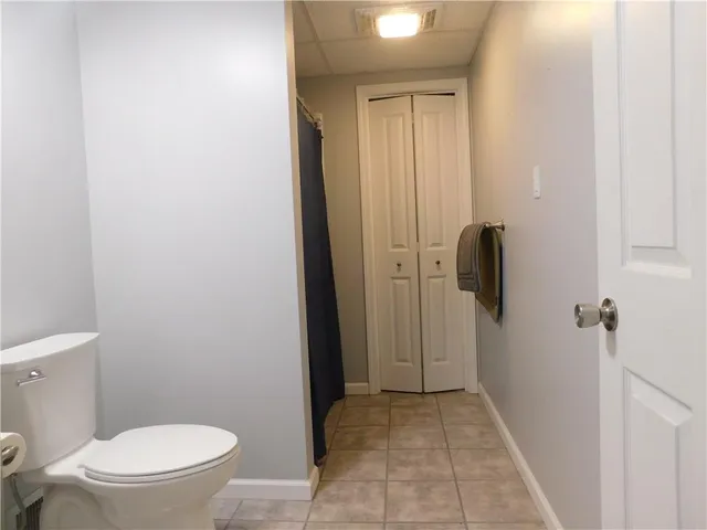 a bathroom with a toilet and a shower