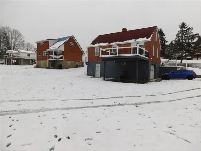 a view of houses with snow on the road