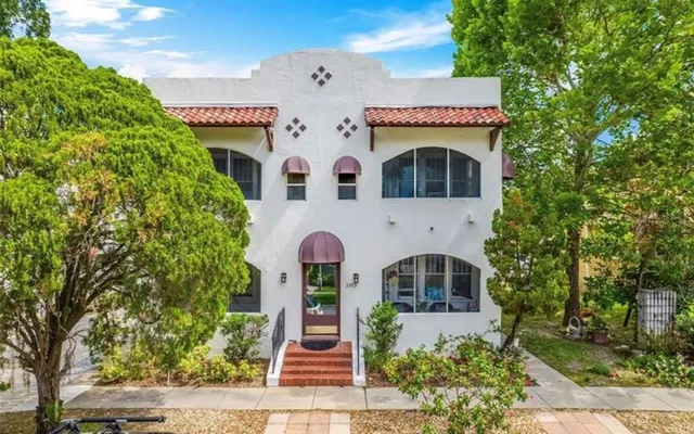 a front view of a building with garden