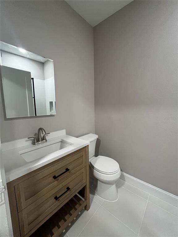 3303 West Empedrado Street, Unit 1 Tampa, FL 33629 - Photo 12 of 16 a bathroom with a granite countertop toilet sink and mirror