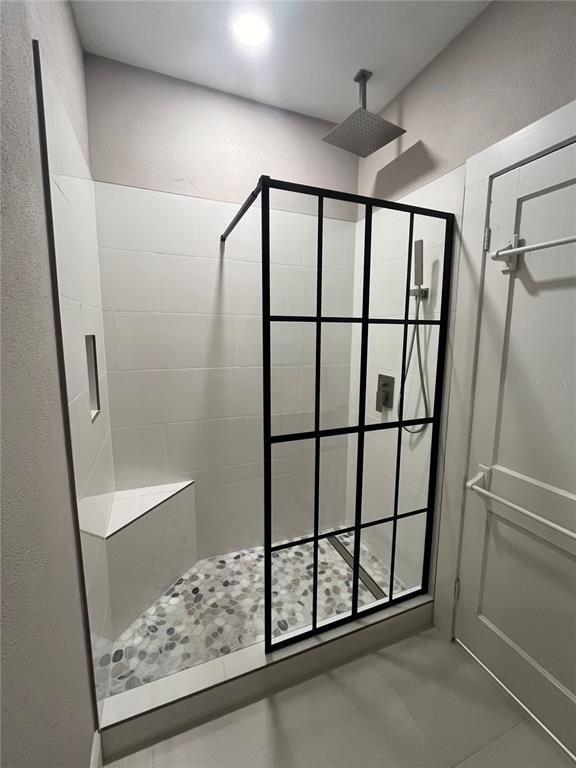 3303 West Empedrado Street, Unit 1 Tampa, FL 33629 - Photo 13 of 16 a bathroom with a glass shower door