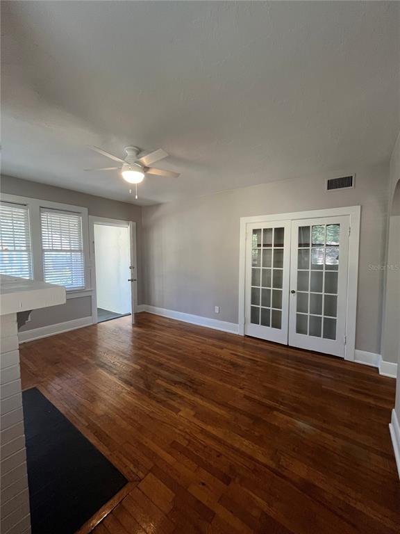 3303 West Empedrado Street, Unit 1 Tampa, FL 33629 - Photo 4 of 16 an empty room with wooden floor and windows