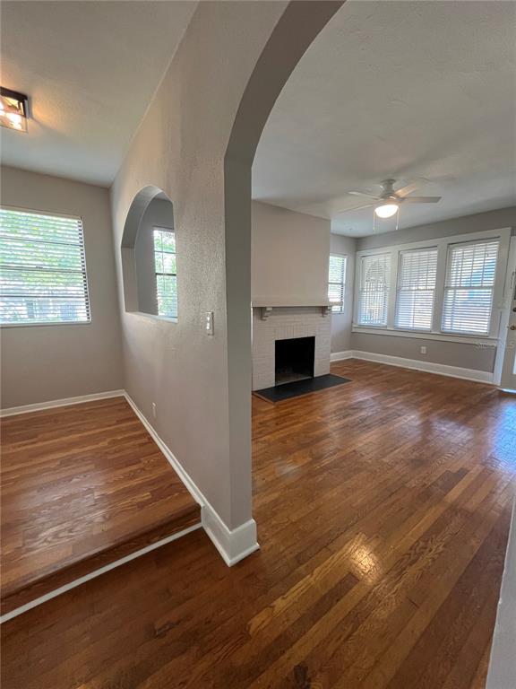 3303 West Empedrado Street, Unit 1 Tampa, FL 33629 - Photo 7 of 16 an empty room with wooden floor fireplace and windows