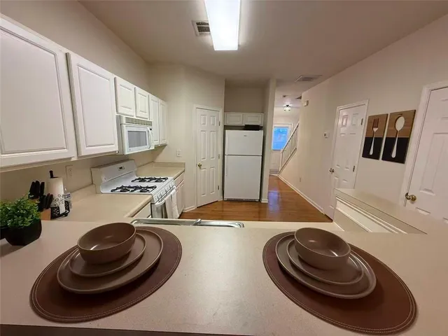 a kitchen with a sink a stove and cabinets