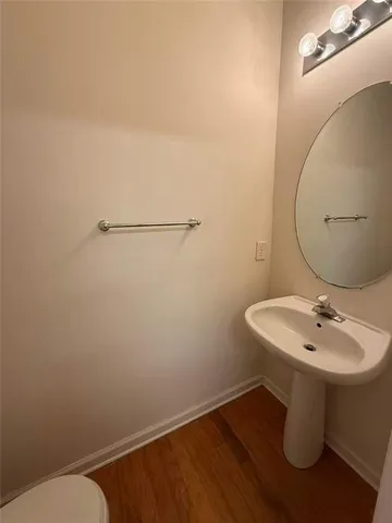 a bathroom with a sink a toilet and mirror