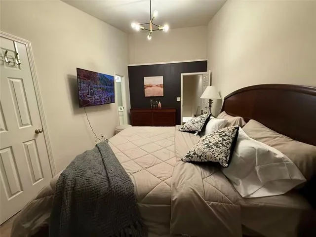 a bedroom with a bed and a wall painting