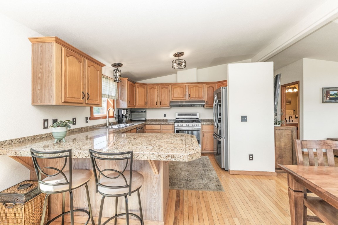 26870 Beaver Canyon Drive Clark, CO 80428 - Photo 12 of 50 a kitchen with stainless steel appliances granite countertop a sink and cabinets