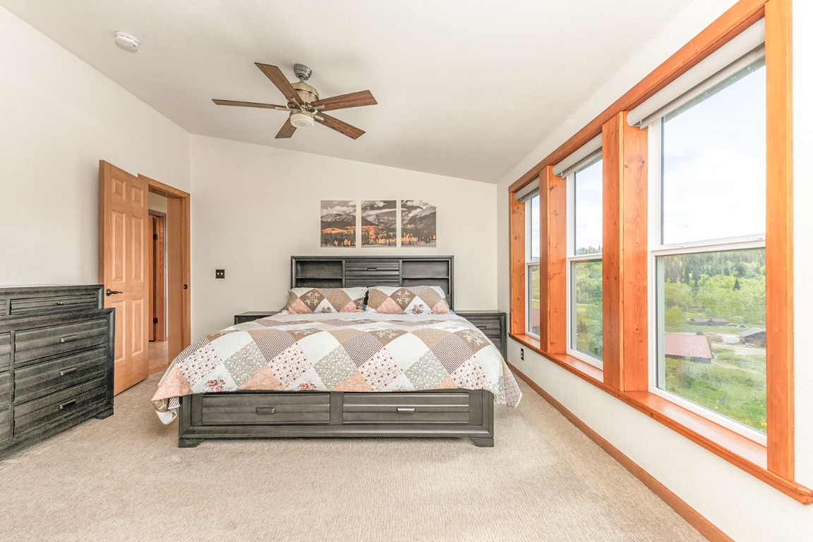 26870 Beaver Canyon Drive Clark, CO 80428 - Photo 23 of 50 a bed sitting in a spacious bedroom next to a window