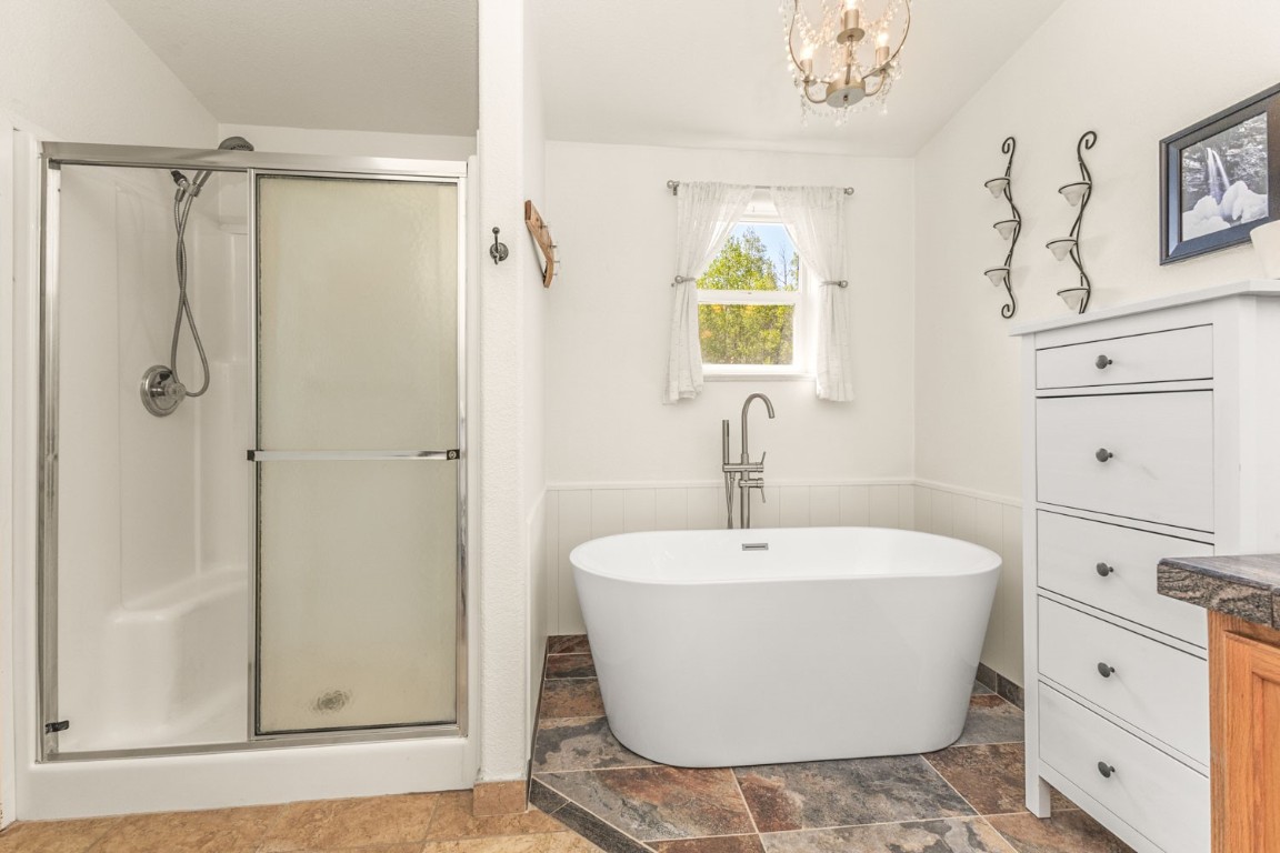 26870 Beaver Canyon Drive Clark, CO 80428 - Photo 26 of 50 a white bath tub sitting next to a white sink