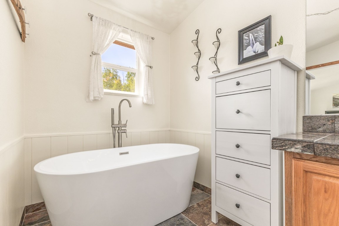 26870 Beaver Canyon Drive Clark, CO 80428 - Photo 27 of 50 a white bath tub sitting next to a bathroom sink