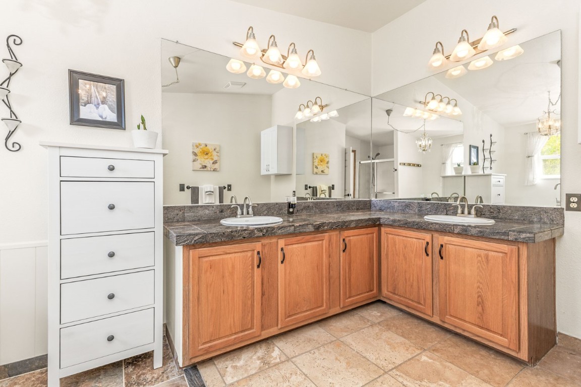 26870 Beaver Canyon Drive Clark, CO 80428 - Photo 28 of 50 a large bathroom with a granite countertop sink a large mirror and vanity