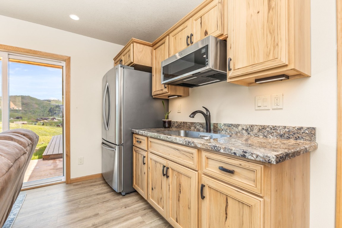 26870 Beaver Canyon Drive Clark, CO 80428 - Photo 30 of 50 a kitchen with stainless steel appliances granite countertop a refrigerator and microwave