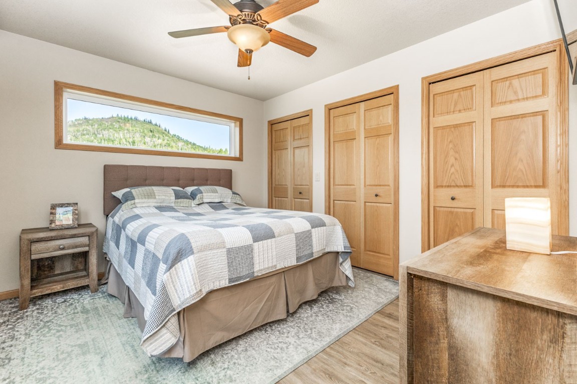 26870 Beaver Canyon Drive Clark, CO 80428 - Photo 32 of 50 a bedroom with a large bed and a chandelier