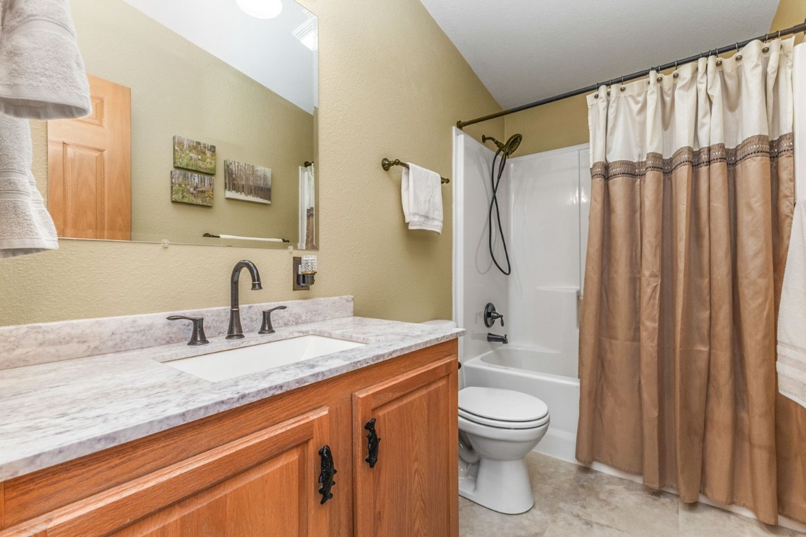 26870 Beaver Canyon Drive Clark, CO 80428 - Photo 35 of 50 a bathroom with a granite countertop sink toilet a mirror and shower