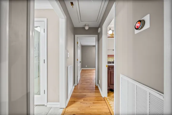a view of a hallway with wooden floor and entryway