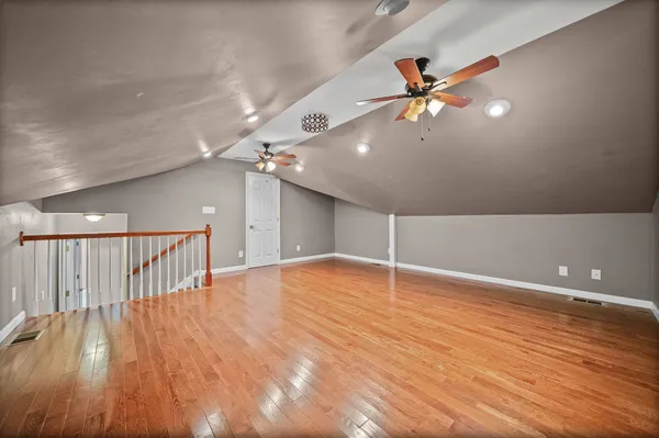 a view of an empty room with wooden floor
