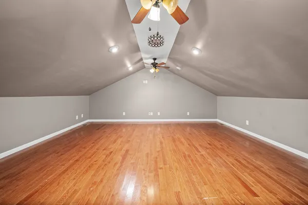a view of a room with wooden floor