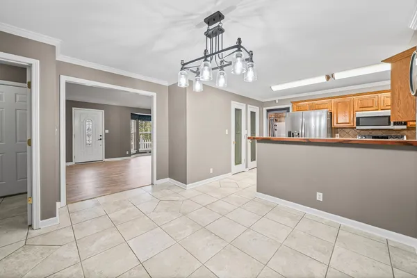 a view of a livingroom with a chandelier furniture and windows