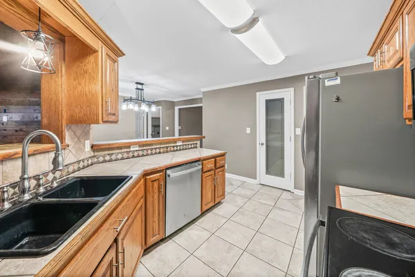 a kitchen with stainless steel appliances granite countertop a sink and cabinets