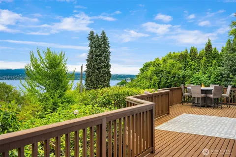 a balcony with wooden floor and fence