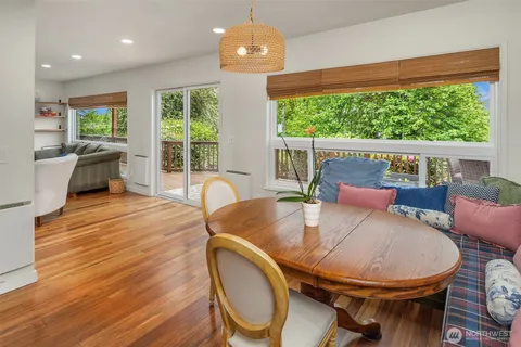 a view of a dining room with furniture window and wooden floor