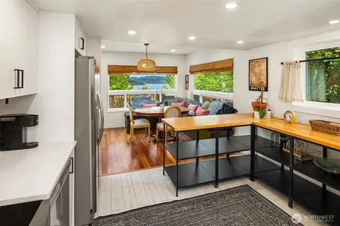 a very nice looking living room with a large window and wooden floor