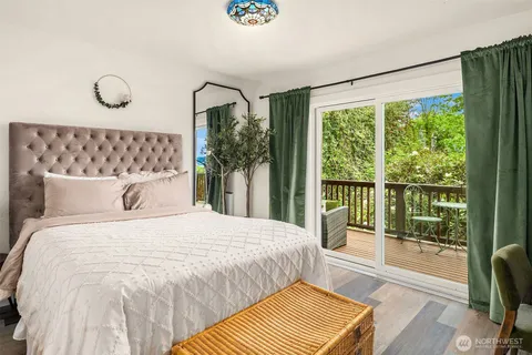 a bedroom with a large bed and a large window