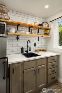 a kitchen with a sink a stove and cabinets