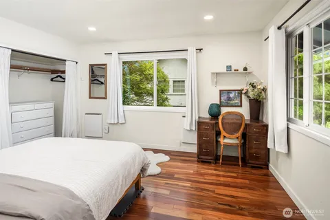 a spacious bedroom with a bed and a chair