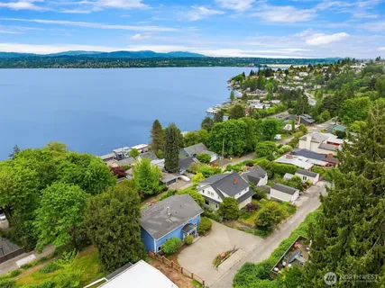 an aerial view of lake and residential houses with outdoor space