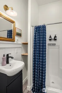a bathroom with a sink a shower and a mirror