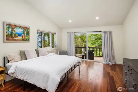 a bedroom with a large bed and a large window