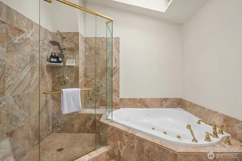 a bathroom with a tub and shower