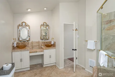 a bathroom with double vanity sinks and a mirror