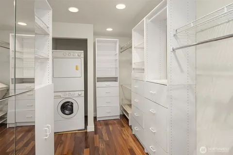 a view of walk in closet with clothes and shoes