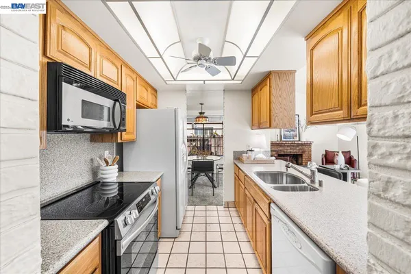 a kitchen with a sink and a stove top oven